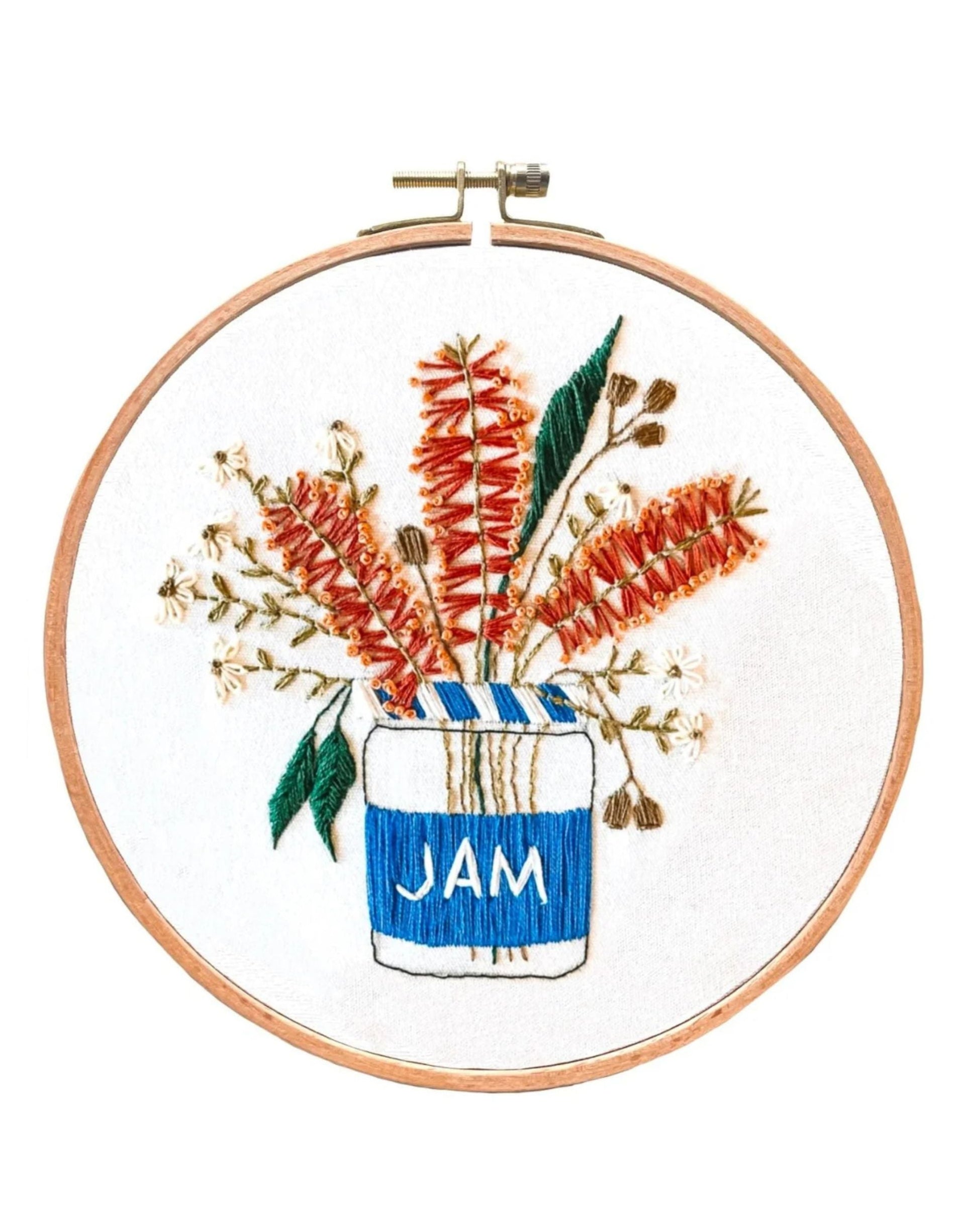 Blue Jam Bottlebrush embroidery hoop art featuring orange bottlebrush flowers and green leaves in a blue and white jam jar