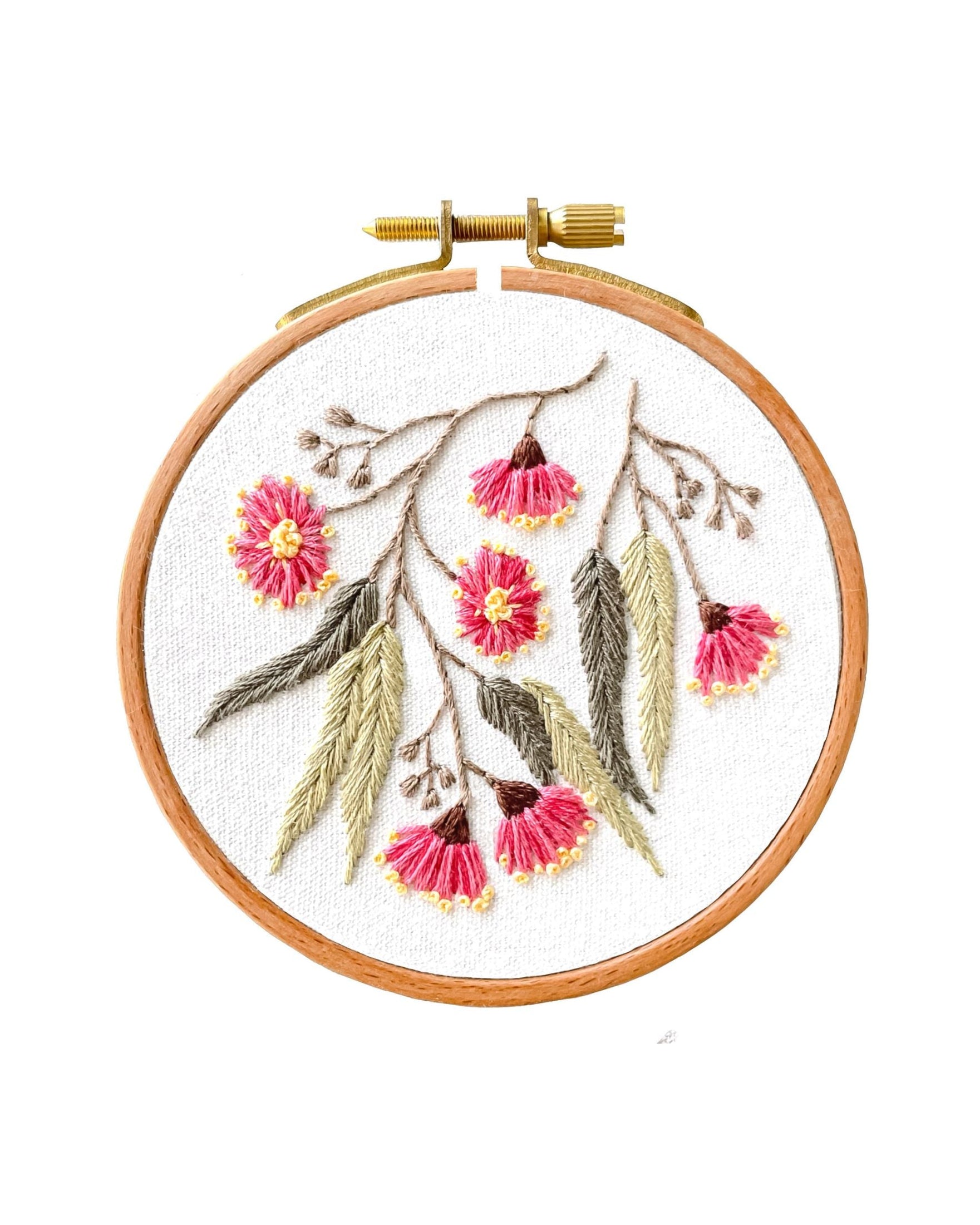 Mini Flowering Gum embroidery hoop featuring pink eucalyptus blossoms with sage green leaves on white fabric background