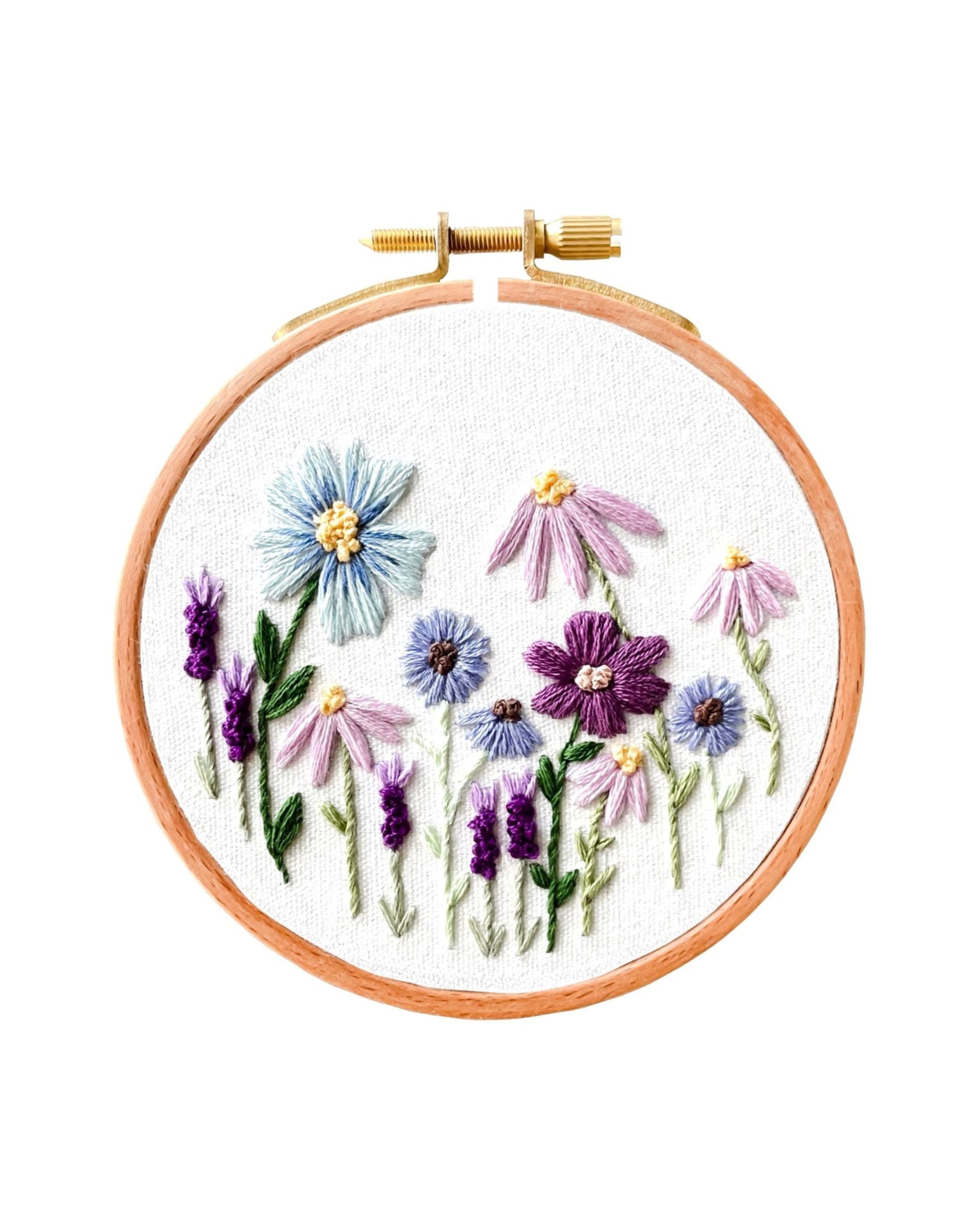 Mini Purple Wildflowers embroidery hoop art with various stitched purple and blue wildflowers on white fabric.
