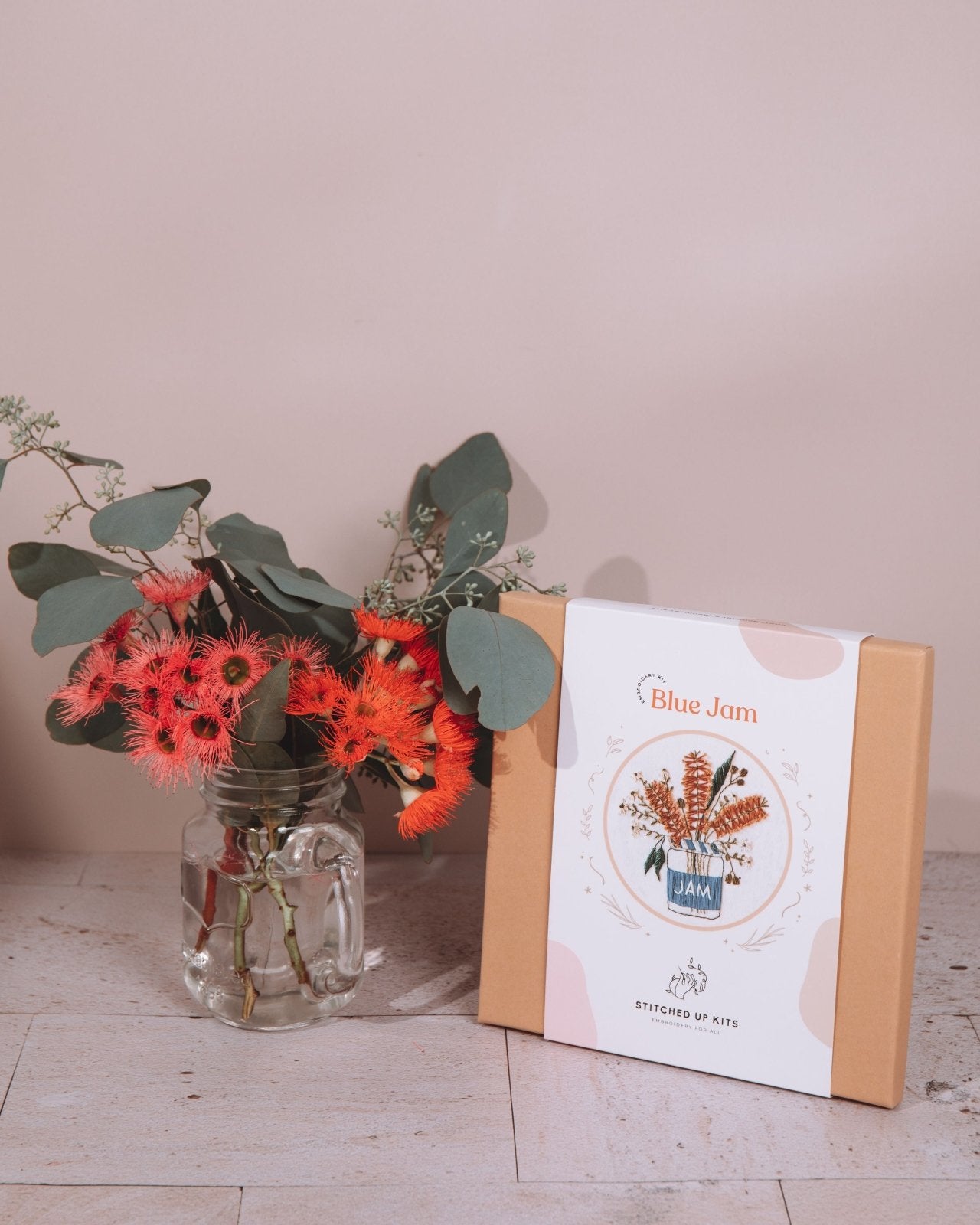 The Blue Jam embroidery kit gift box sitting next to a jar of Australian Native flowers